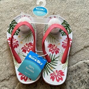 Red and White Casual Flip Flop Sandals with Floral Design..